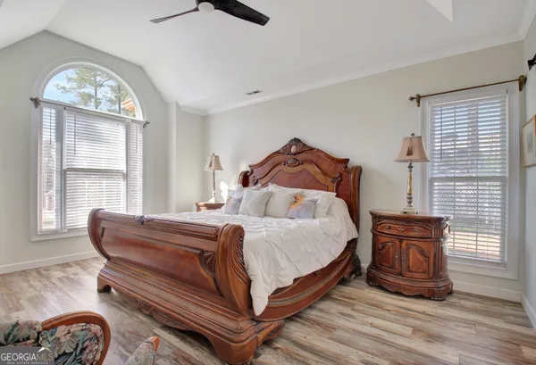 a bed sitting in a bedroom next to a window