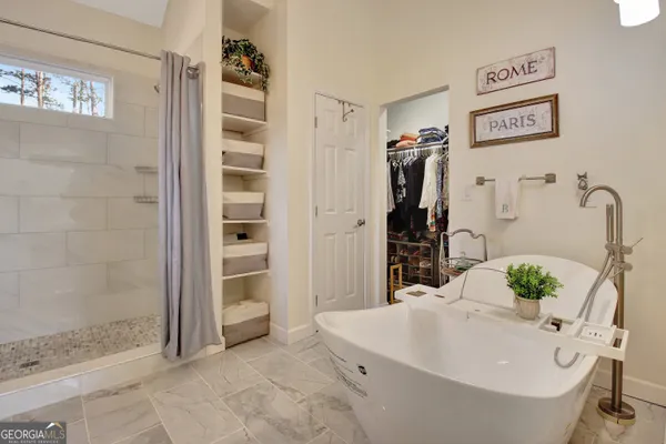 a bathroom with a tub and shower