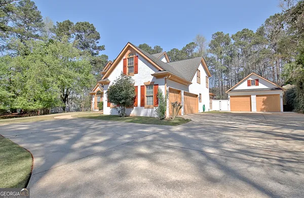 a view of a house with a yard and garage