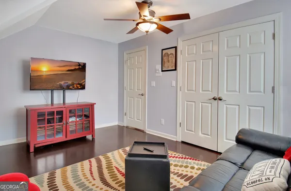 a living room with furniture and a flat screen tv