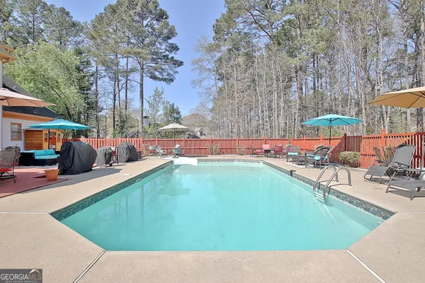 a view of a swimming pool with lounge chairs