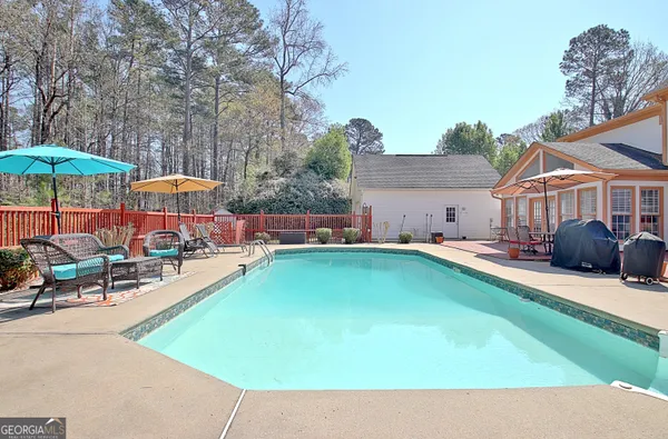 an outdoor space with pool and furniture