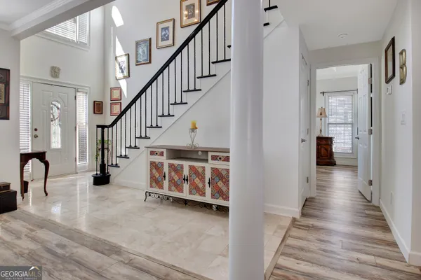 a view of entryway and hall with wooden floor