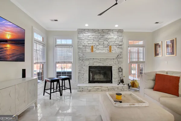 a living room with furniture a flat screen tv and a fireplace