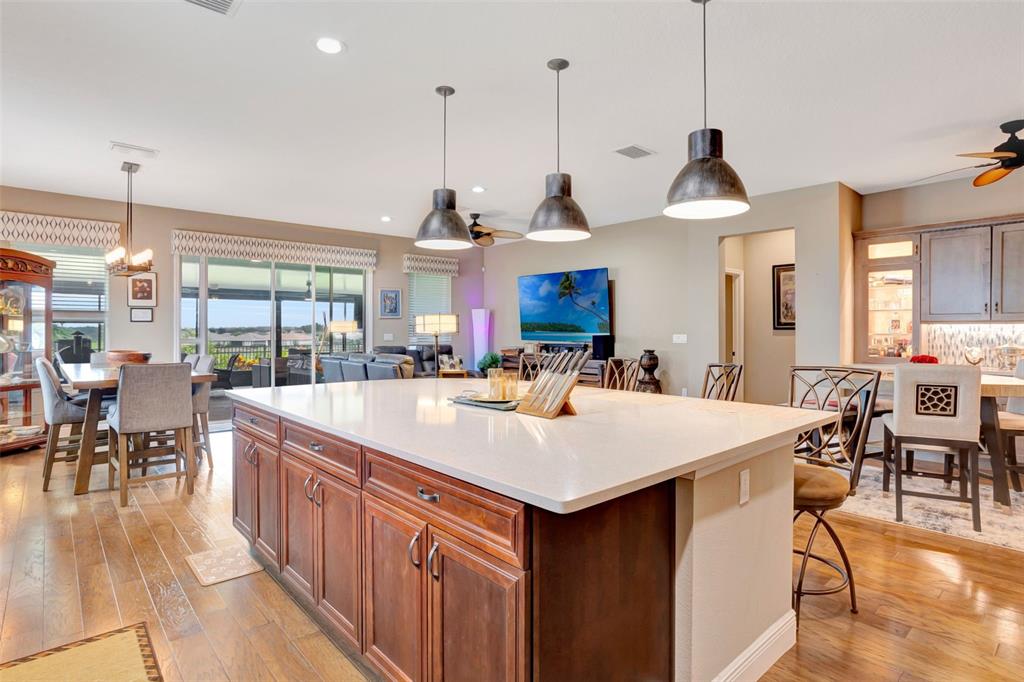 176 Silver Maple Road Groveland, FL 34736 - Photo 13 of 45 a large kitchen with kitchen island a large island in it