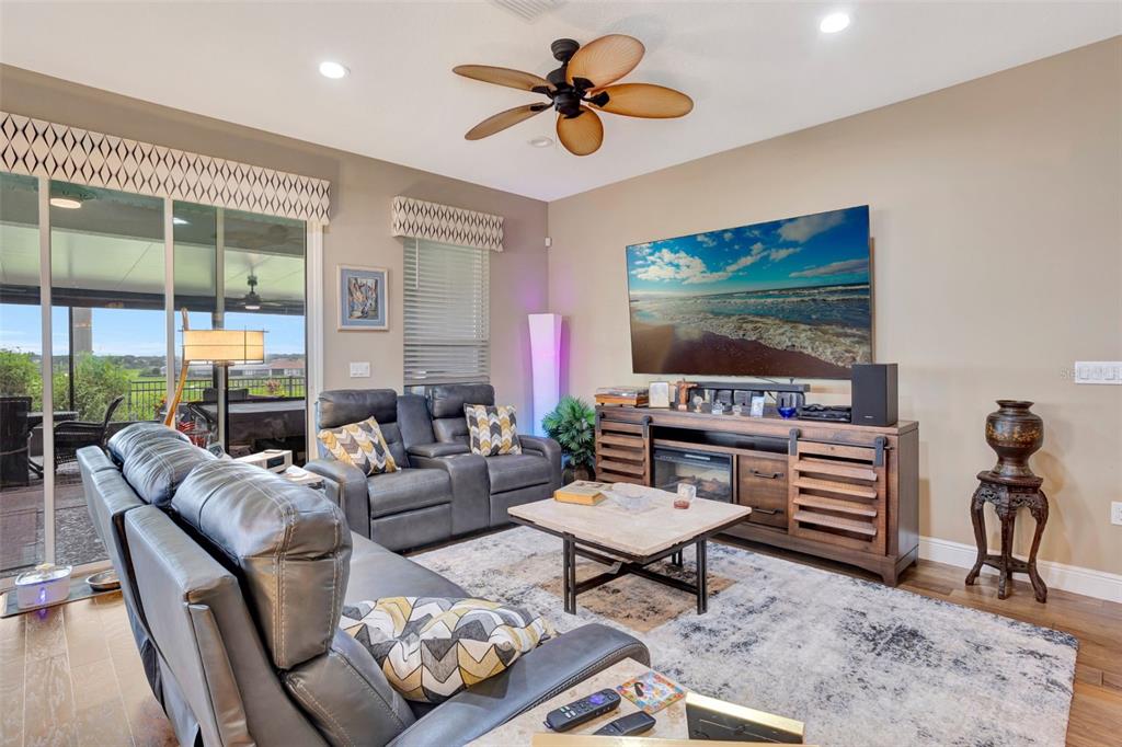 176 Silver Maple Road Groveland, FL 34736 - Photo 16 of 45 a living room with furniture and a flat screen tv