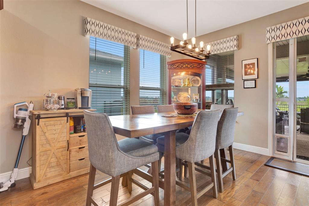 176 Silver Maple Road Groveland, FL 34736 - Photo 20 of 45 a view of a dining room with furniture window and wooden floor