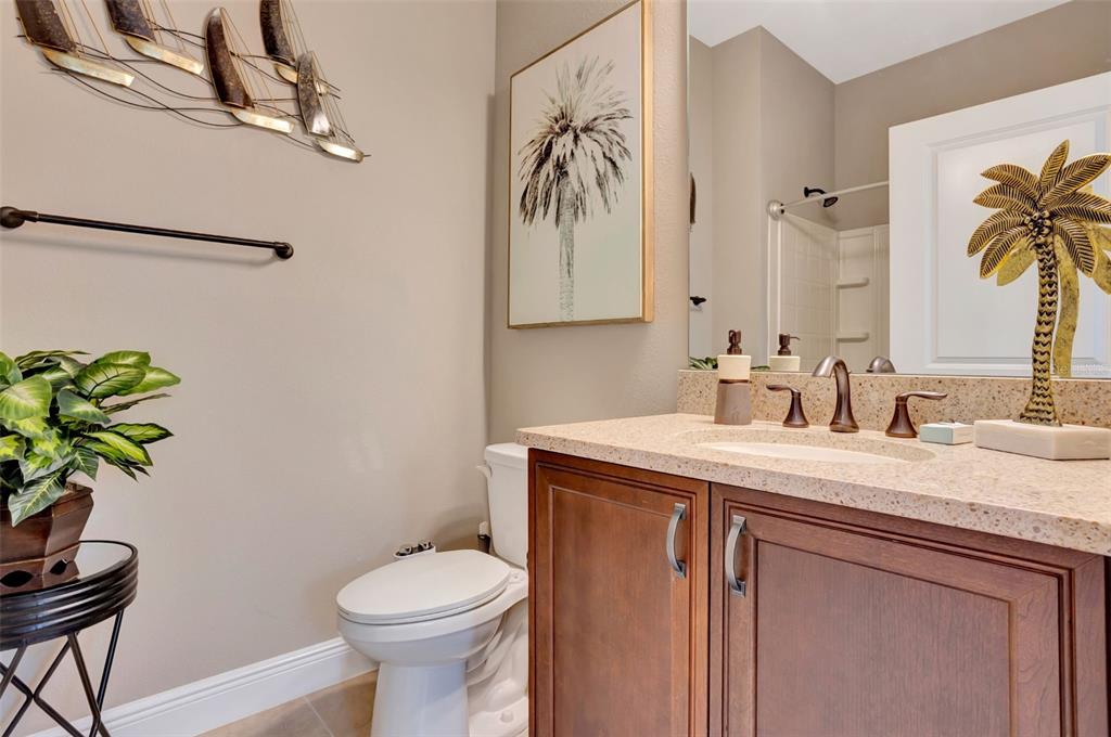 176 Silver Maple Road Groveland, FL 34736 - Photo 28 of 45 a bathroom with a toilet sink and mirror