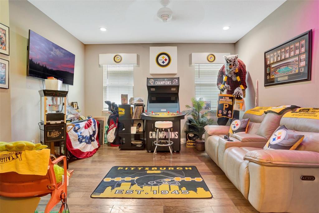 176 Silver Maple Road Groveland, FL 34736 - Photo 29 of 45 a living room with furniture flat screen tv and a table