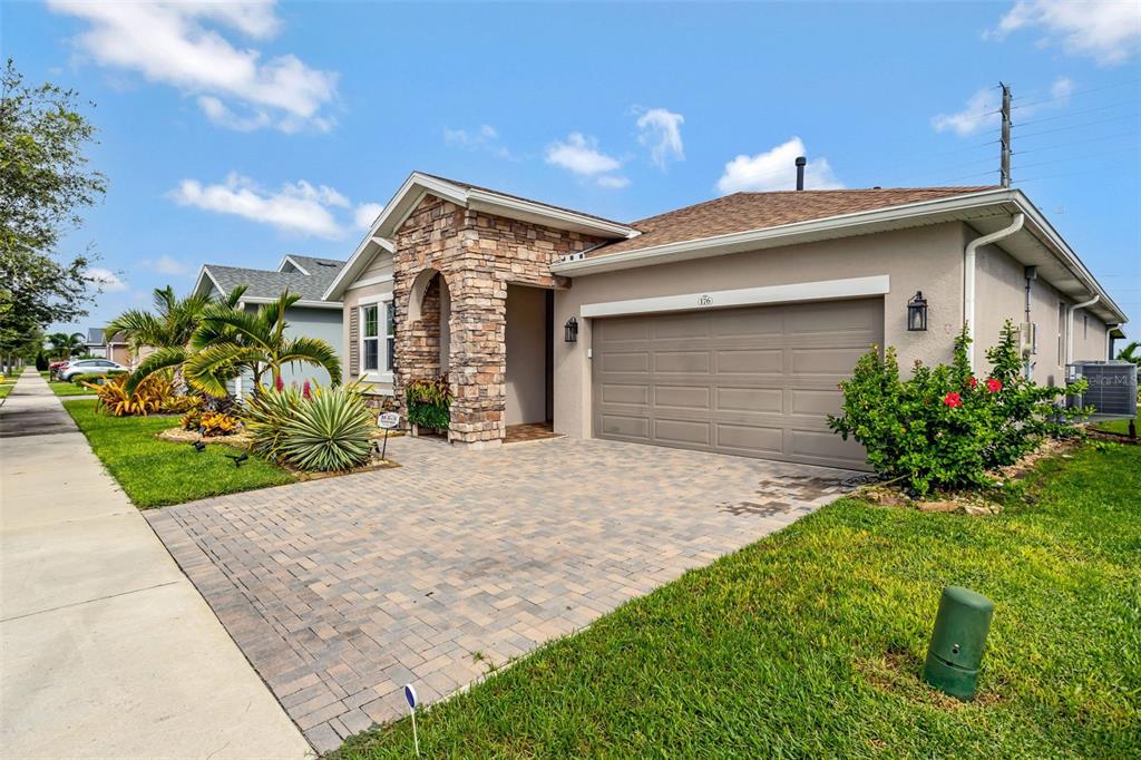176 Silver Maple Road Groveland, FL 34736 - Photo 3 of 45 a front view of a house with a yard and potted plants