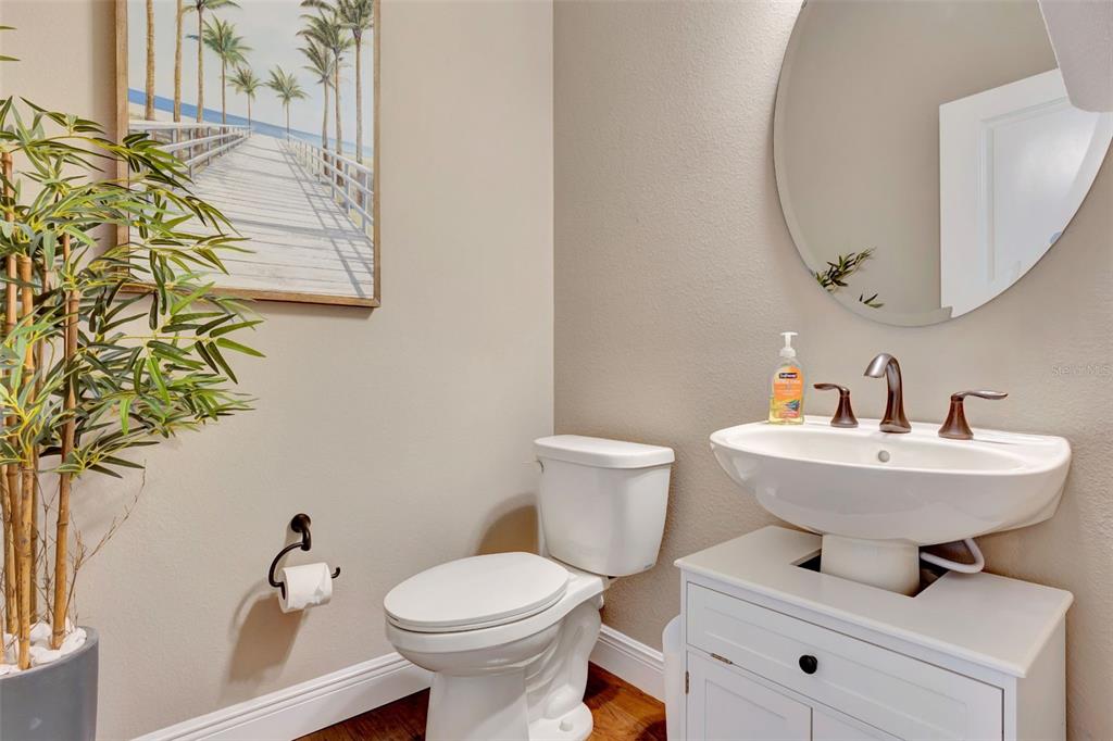 176 Silver Maple Road Groveland, FL 34736 - Photo 32 of 45 a bathroom with a sink mirror and toilet