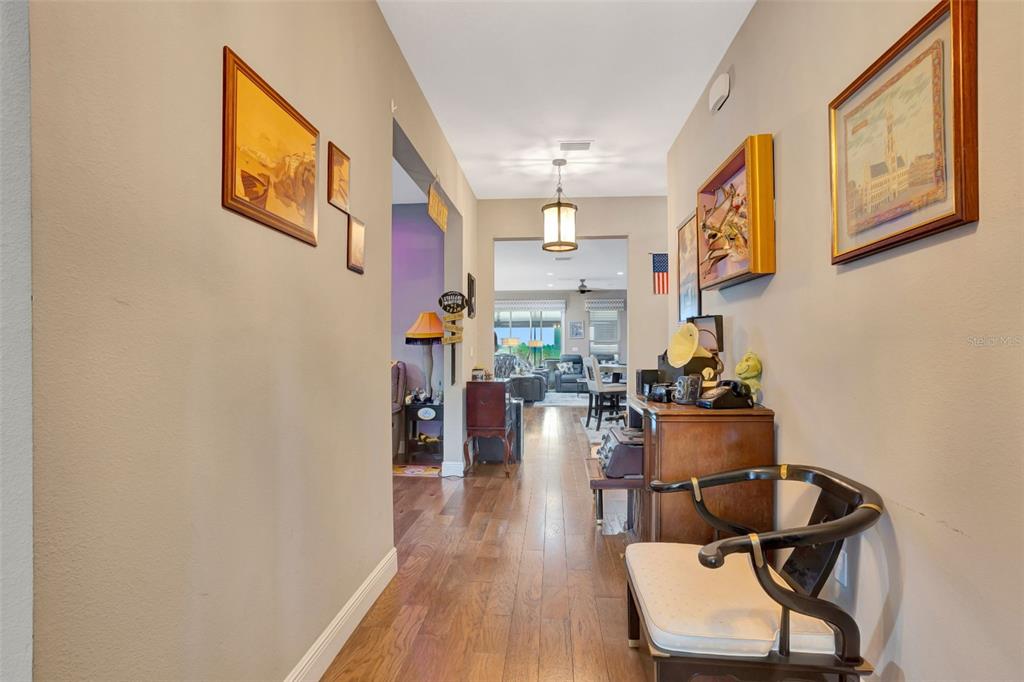 176 Silver Maple Road Groveland, FL 34736 - Photo 7 of 45 a living room with furniture and wooden floor