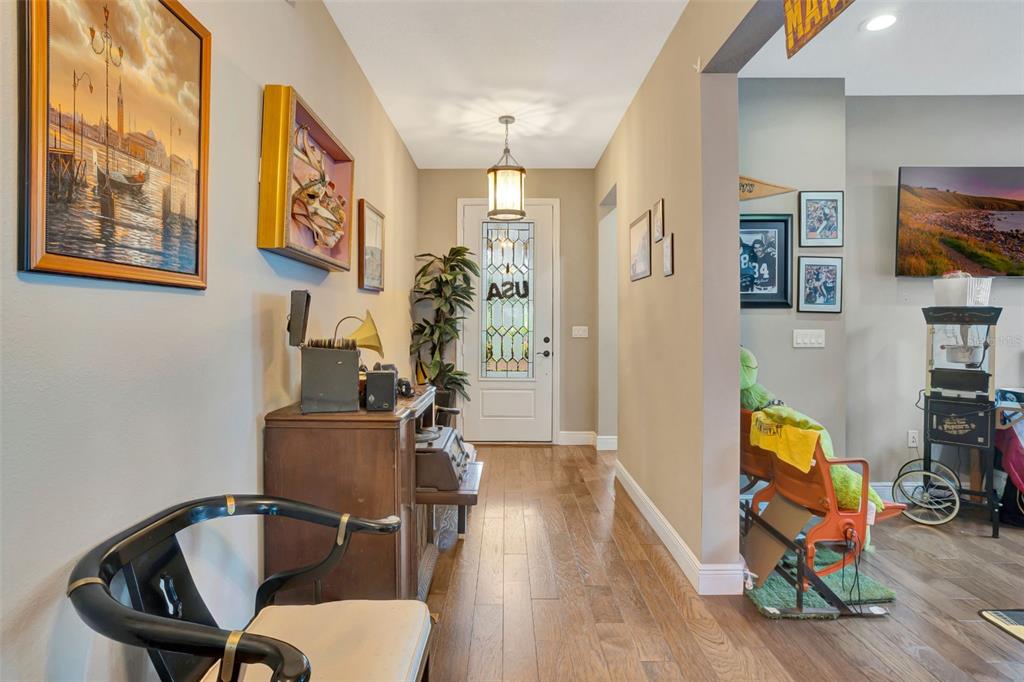 176 Silver Maple Road Groveland, FL 34736 - Photo 8 of 45 a view of a workspace with furniture and wooden floor