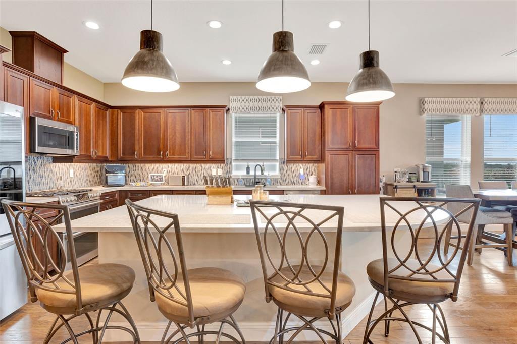 176 Silver Maple Road Groveland, FL 34736 - Photo 9 of 45 a kitchen with a dining table and chairs