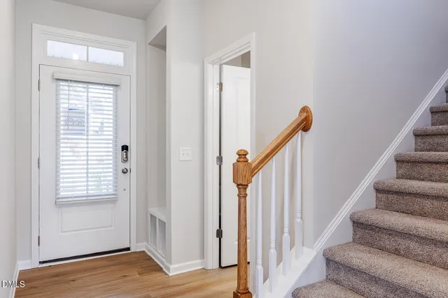 a view of entryway with wooden floor and stairs