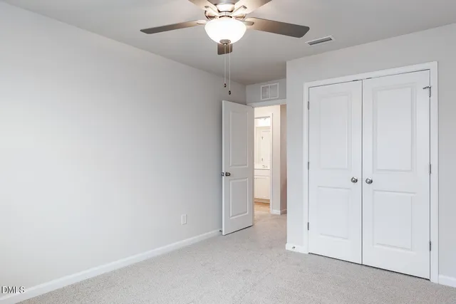 a view of a chandelier fan and entryway in a room