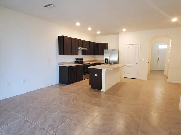 a large kitchen with cabinets and stainless steel appliances