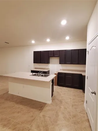 a kitchen with stainless steel appliances a stove a sink and a refrigerator