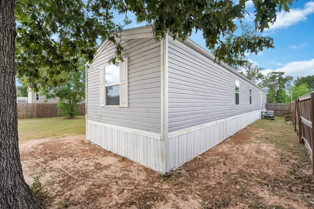 a view of a small yard with wooden fence
