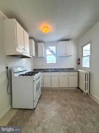 a kitchen with a sink cabinets and window