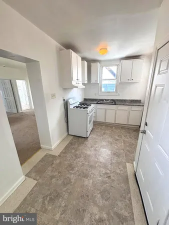 a view of a kitchen with furniture and a window