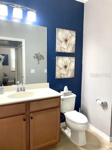 a bathroom with a toilet a sink and mirror
