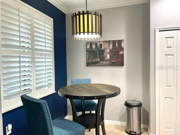 a view of a dining room with furniture and window