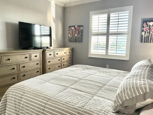 a bedroom with a bed and a flat screen tv