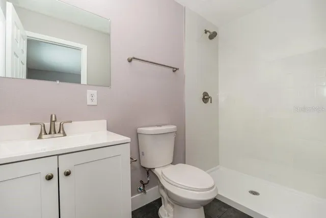 a bathroom with a sink toilet and shower