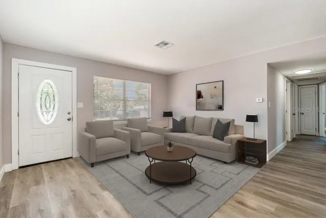 a living room with furniture and a large window