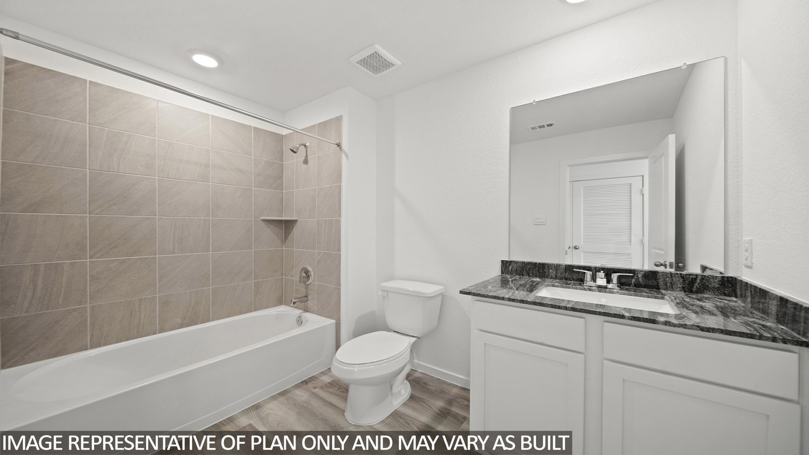417 Old Stage Coach Road Jarrell, TX 76537 - Photo 15 of 17 Bathroom featuring a tiled tub-shower combination with an integrated shelf, a white toilet, and a vanity with a dark patterned countertop, an integrated sink, a chrome faucet, and a large wall-mounted mirror
