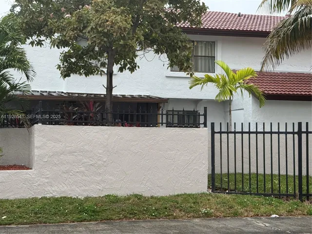 a view of a house with a iron fence