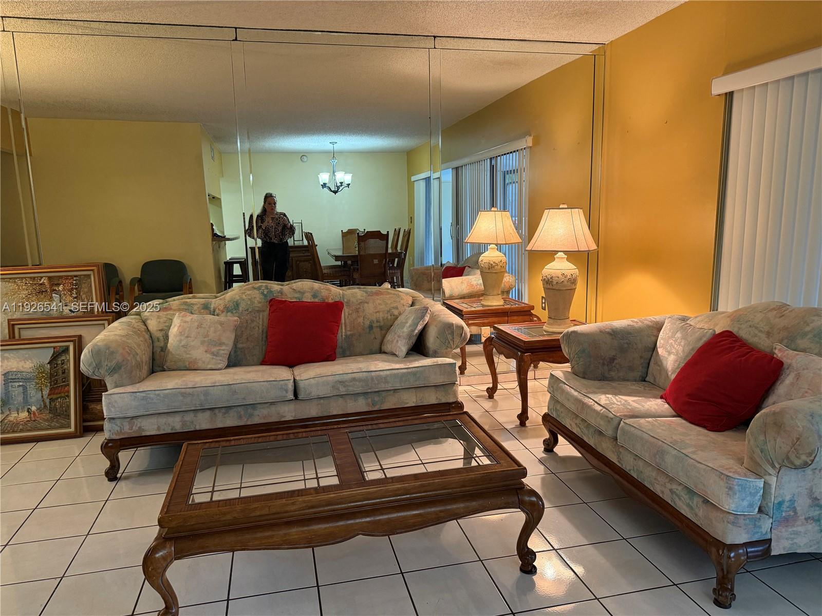 9901 Northwest 9th St Circle, Unit 32 Miami, FL 33172 - Photo 3 of 14 a living room with furniture and a chandelier