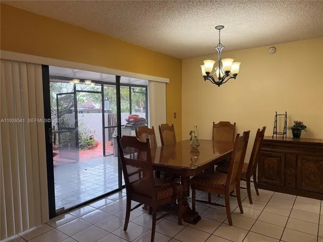 a view of a dining room with furniture wooden floor and chandelier