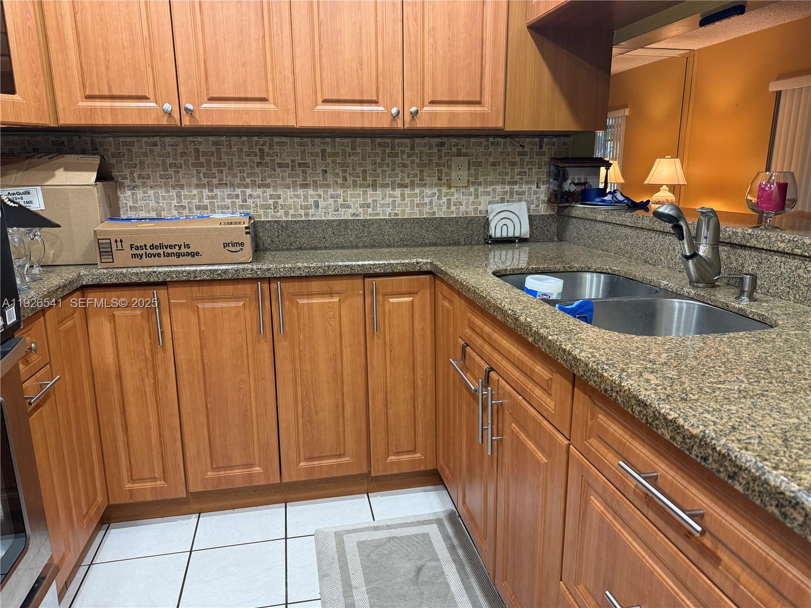 9901 Northwest 9th St Circle, Unit 32 Miami, FL 33172 - Photo 5 of 14 a kitchen with stainless steel appliances granite countertop a sink and cabinets