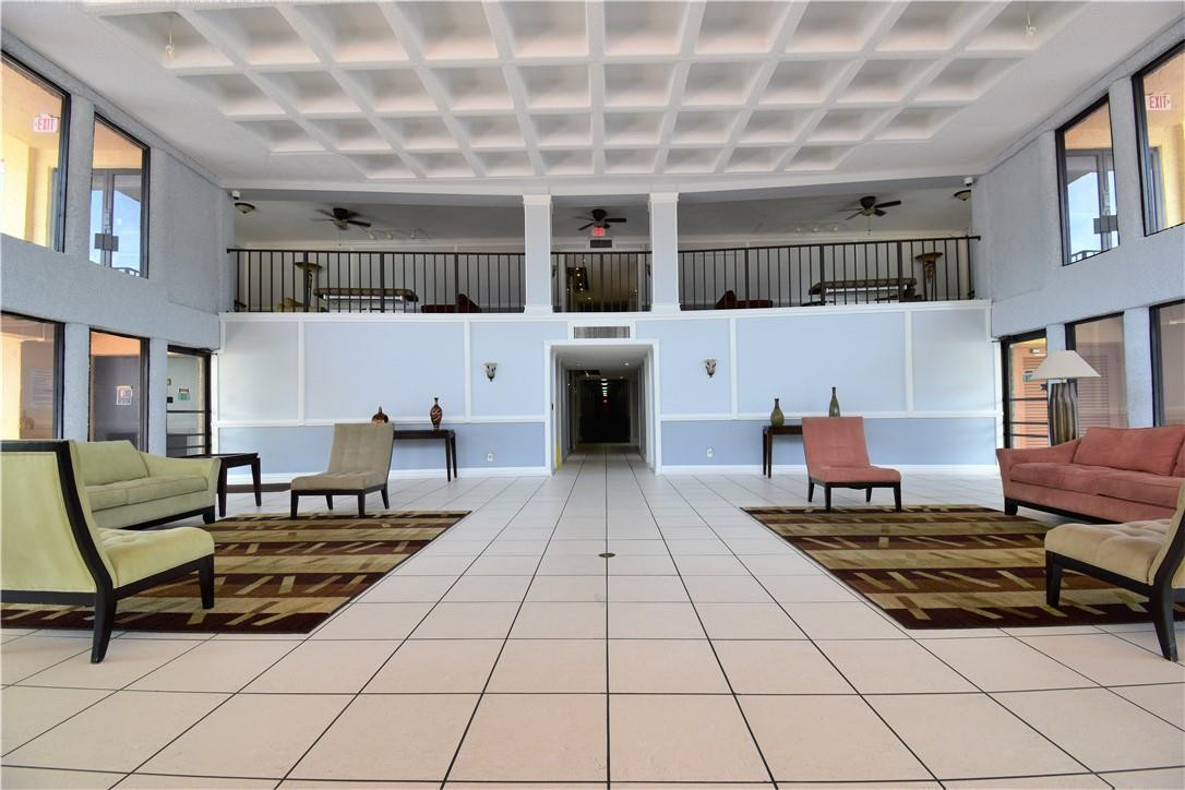 9273 Southwest 8th Street, Unit 407 Boca Raton, FL 33428 - Photo 19 of 19 a living room with furniture and a table