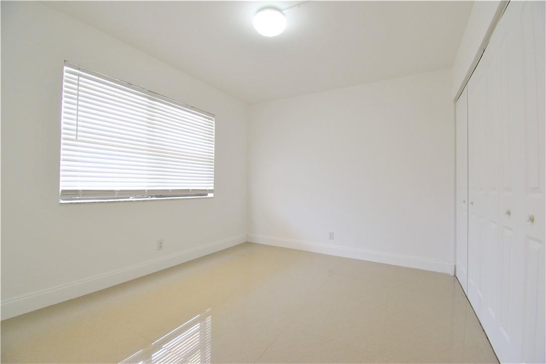 9273 Southwest 8th Street, Unit 407 Boca Raton, FL 33428 - Photo 9 of 19 an empty room with a window