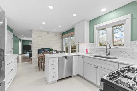 a kitchen with a sink stove and cabinets