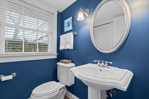 a bathroom with a sink a mirror and a toilet