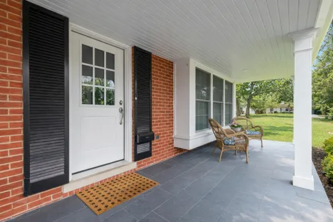 a bench sitting in front of a house