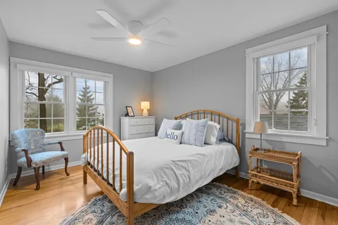 a bedroom with a bed and a large window with outer view