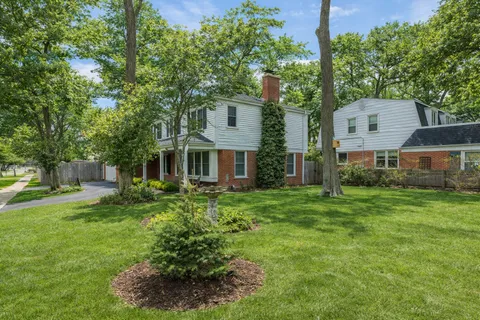 a view of a house with a yard and tree s