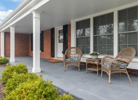 a outdoor space with a large window and furniture