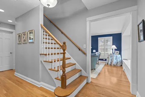 a view of entryway and hall with wooden floor