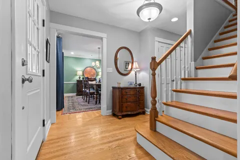 a view of a hallway with wooden floor and entryway