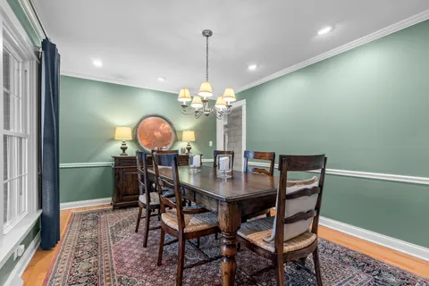 a view of a dining room with furniture and chandelier