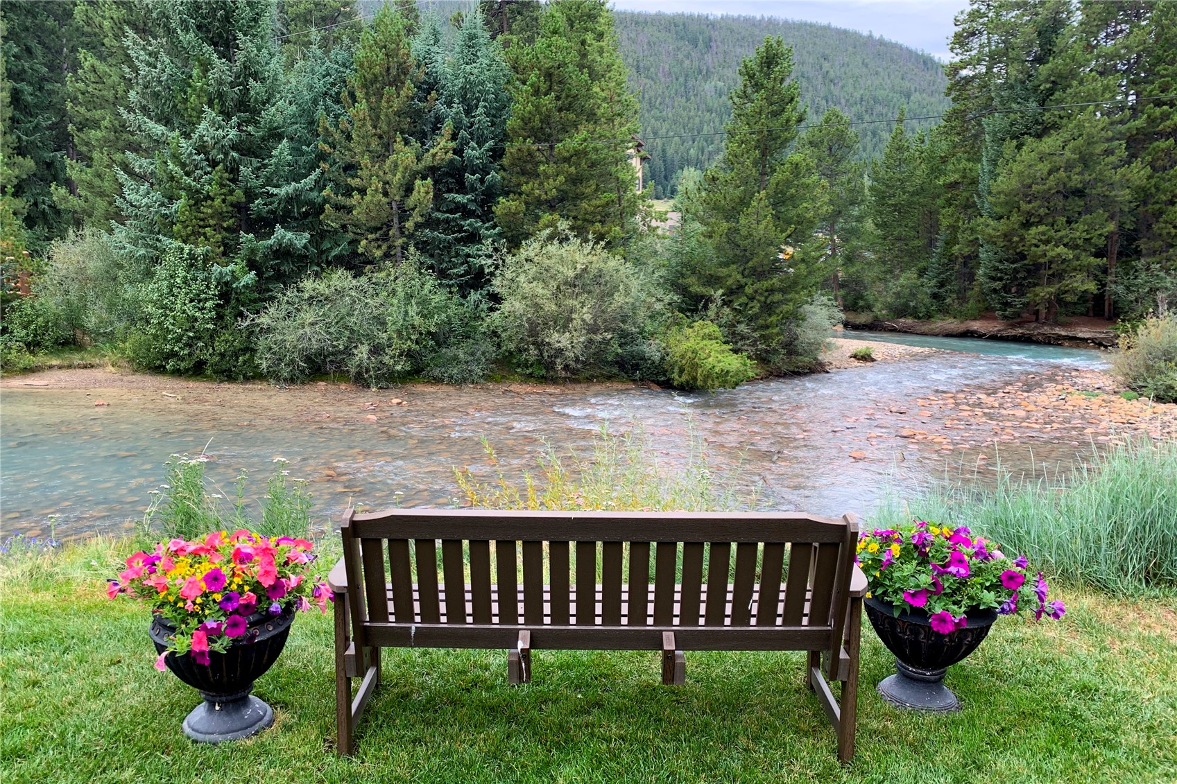 23034 Highway 6, Unit 305 Keystone, CO 80435 - Photo 27 of 27 a view of a garden with flowers and trees