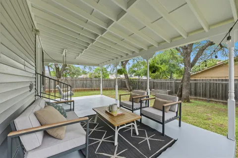 a view of a house with backyard and sitting area
