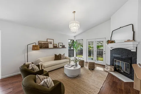 a living room with furniture and a fireplace