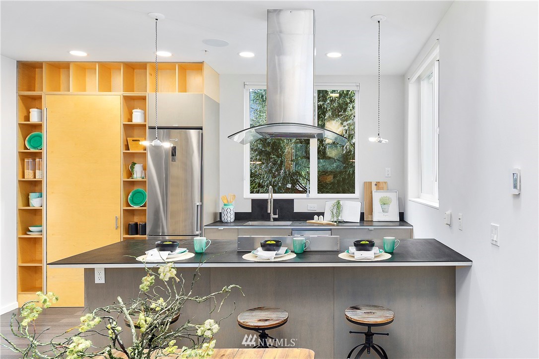 1623 14th Avenue, Unit E Seattle, WA 98122 - Photo 11 of 40 a kitchen with a window and chairs